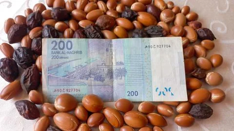 Moroccan 200 dirham banknote over Argan seeds Stock Photos