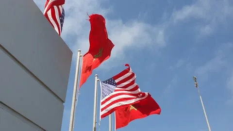 Moroccan and US Flags waving against blue sky Stock Footage 157396540