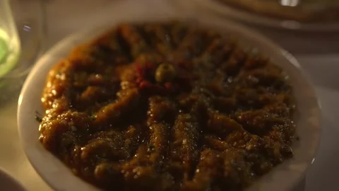 Moroccan appetizer eggplant roasted pepper dish by candle light Stock Footage 165791486