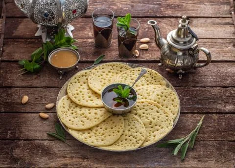 Moroccan breakfast with Baghrir, mint tea and honey, copy space Stock Photos