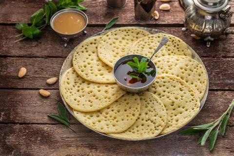 Moroccan breakfast with Baghrir, mint tea and honey, copy space Stock Photos
