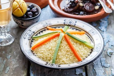 Moroccan couscous topped with vegetables. Rustic style. Stock Photos