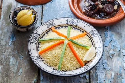 Moroccan couscous topped with vegetables. Rustic style. Stock Photos