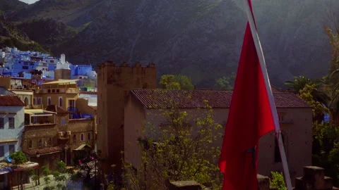 Moroccan Flag Flying Over Chefchaouen Kasbah Drone Flyby Stock-Footage 336573723