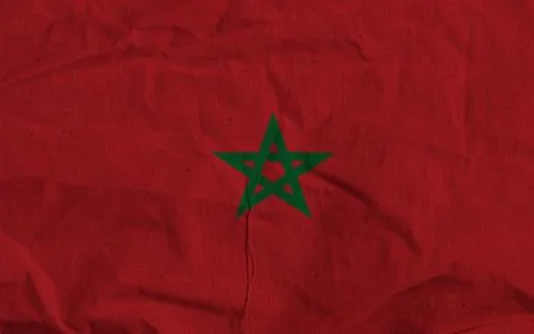Moroccan Flag With Green Five-Point Star On Red Fabric, Bold National Symbol Bac Stock Photos