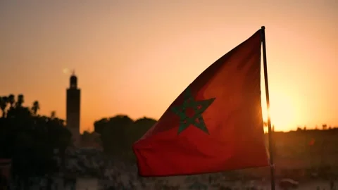 Moroccan Flag Waving in Marrakesh at Sunset with Traditional Background Stock Footage 313566034