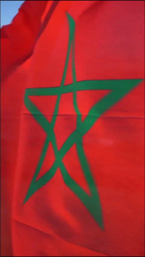 Moroccan flag waving under the sun outdoor on windy weather in the beach Stock Footage 296753779