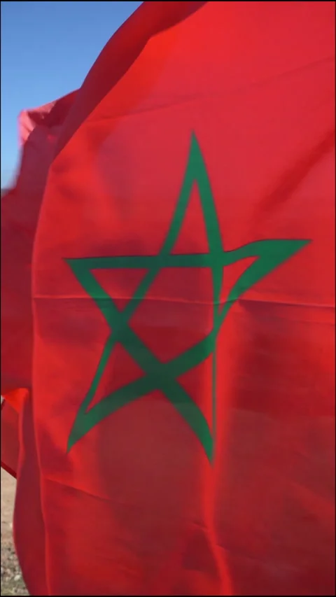 Moroccan flag waving under the sun outdoor on windy weather in the beach Stock Footage 296753784
