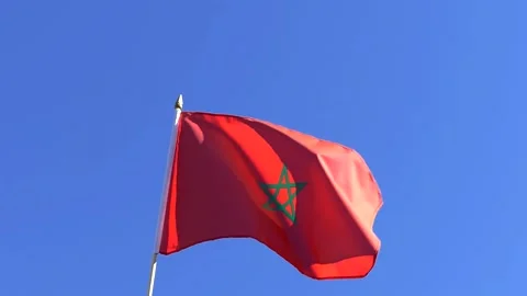 The Moroccan flag waving in the wind in the blue sky Stock Footage 282432837