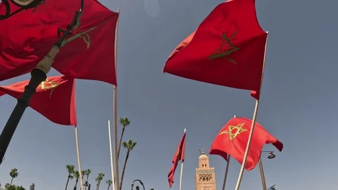 Moroccan flags waving with Koutoubia Mosque in Marrakech, Morocco. Stock Footage 337766683