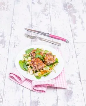 Moroccan lamb meatballs with pine nuts on a bed of salad Foto stock