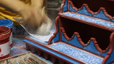 The Moroccan is making some decoration to his multicolor woodwork art Stock Footage 124064469