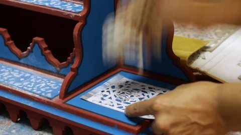 The Moroccan is making some decoration to his multicolor woodwork art Stock Footage 124064545