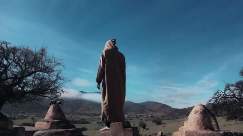 Moroccan Man in Djellaba Overlooking Mountain Landscape Stock-Footage 332770993
