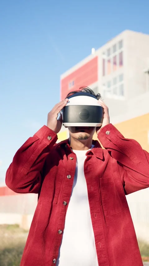 Moroccan man putting on virtual reality headset outdoors. Vertical Stock Footage 340170747