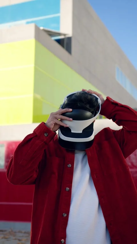 Moroccan man wearing virtual reality headset in the city. Vertical Stock Footage 343643852