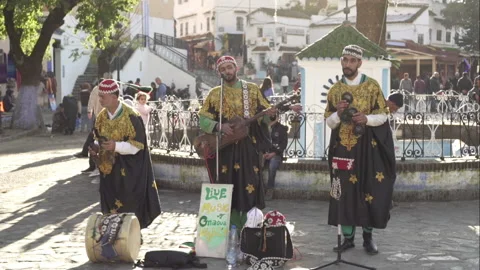 Moroccan men dancing and playing the tradicional Morroccan Gnawa music Stock Footage 134628557