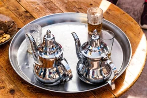 The Moroccan mint tea ceremony, two silver teapots on a tray and three shot g Stock Photos