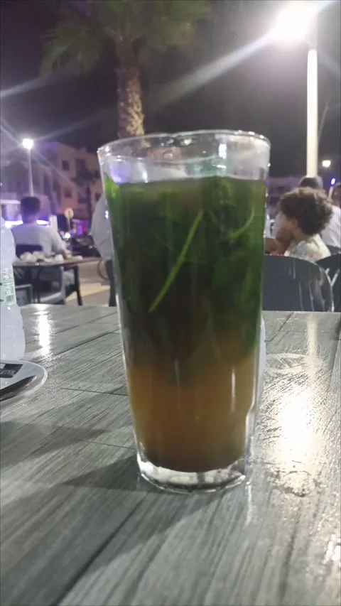 Moroccan Mint Tea Glass on Cafe Table at Night Vídeo Stock 341165466