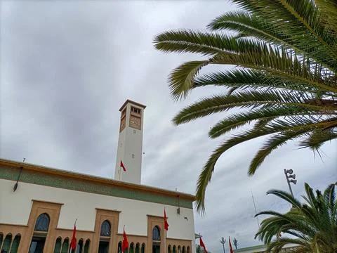Moroccan parliament building with clock tower and palm tree Stock Photos