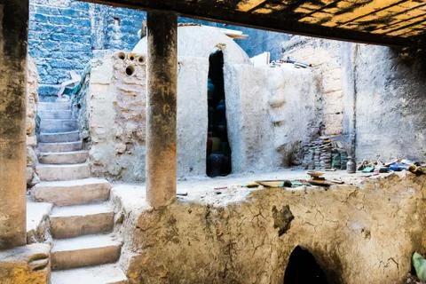 A moroccan pottery maker creates ceramics in a workshop in old medina of Fez, Stock Photos