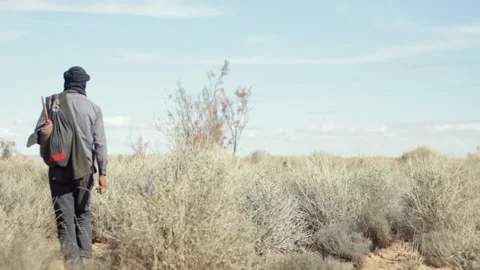 Moroccan Shepherd wandering in the desert Stock Footage 91336017