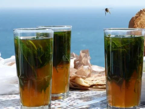 Moroccan tea with bee flying Stock Photos