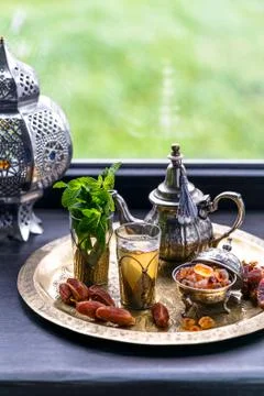 Moroccan tea with mint and sugar in a glasses on a copper plate with kettle Stock Photos