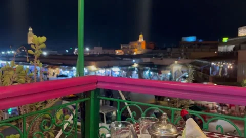 Moroccan tea on a table with views to famous Jemaa el-Fna square Stock Footage 324403966