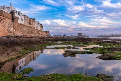 Moroccan town with reflection in low tide lakes at the walls of Skala de la Stock Photos
