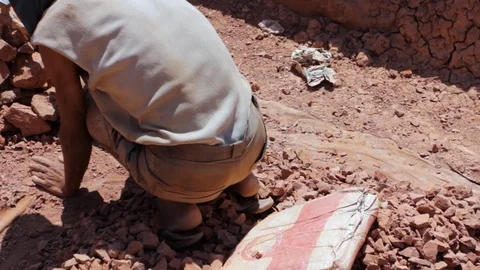 Moroccan worker hitting raw clay  Video stock 124589863