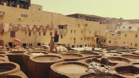 Moroccan Worker Soaking Traditional Leather in the dye pool Stock Footage 271313228