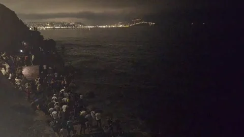 Moroccans continue to arrive at the border with Ceuta despite the fall of night, Stock Footage 340926390