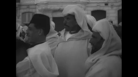 MOROCCO - 1930s - Moroccan men and children watch performers dancing in the Stock Footage 340571503