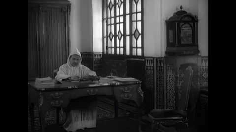 MOROCCO - 1951 - Mohammed V of Morocco is given paperwork to sign. Stock Footage 340659927