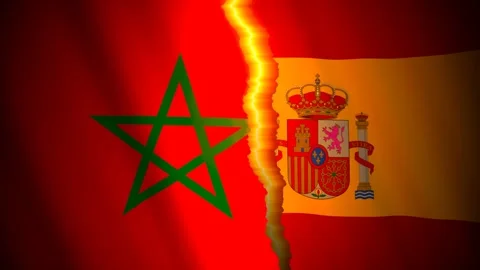 Morocco and Spain flags torn apart along a glowing rift 库存影片 346388047