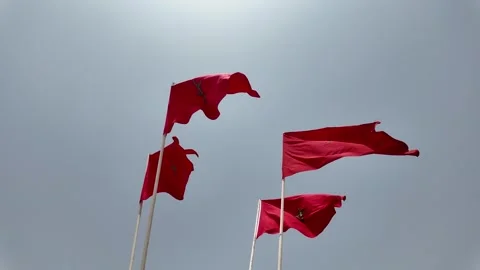 Morocco flags waving at a beautiful and peaceful blue sky in Agadir Stock Footage 280994994