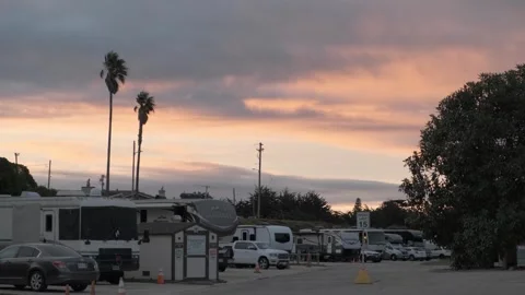 MORRO BAY, CA - DECEMBER 10, 2022 - Sunset over RV park with palm trees Stock Footage 345146460