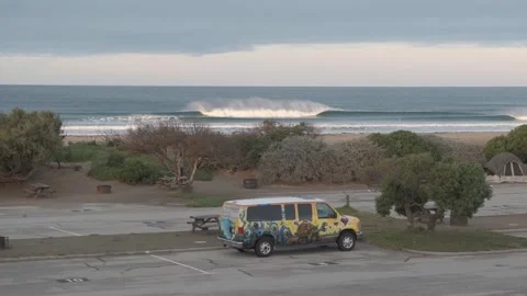 MORRO BAY, CA - DECEMBER 10, 2022 - Painted camper van parked on beach Stock Footage 345146490