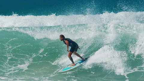 MORRO DAS PEDRAS BEACH, FLORIANOPOLIS, BRAZIL - MAY 01, 2025: Surfer rides the Stock Footage 310684517