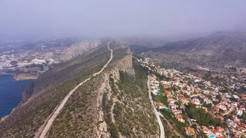 Morro de Toix viewpoint overlooking Calpe, Spain, with rocky ridge, winding Видео 335000566
