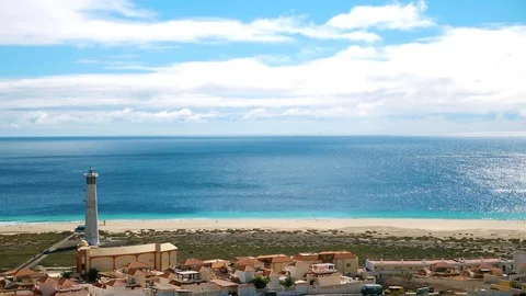 Morro Jable, lighthouse and sea on a sunny day, Fuerteventura Stock Footage 107229610