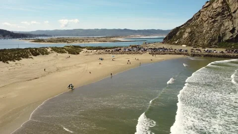 Morro rock beach, Morro bay, aerial view, surfers in the sea Stock Footage 278736102