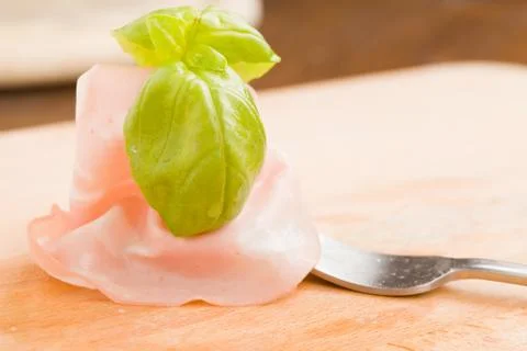 Mortadella with basil Stock Photos