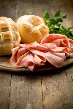 Mortadella with bread on chopping board Stock Photos