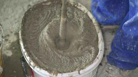 Mortar cement paste, mostly dry, mixed in bucket at house construction site.. Stock-Footage 288143594
