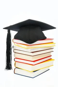 Mortarboard on a book stack Stock Photos