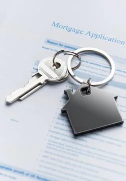 Mortgage application form with house keys representing home ownership Stock Photos