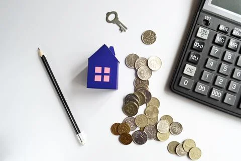 Mortgage concept with stack coins and paper at home and calculator. Stock Photos