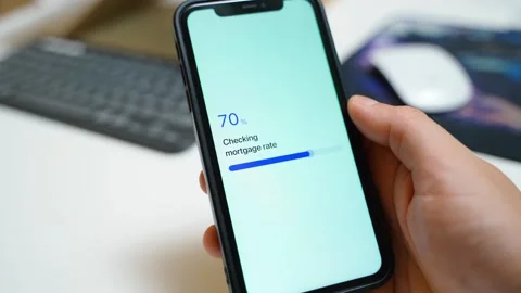 Mortgage rate check stuck at 70 percent on a smartphone in hand. Frozen loading 库存影片 342940446